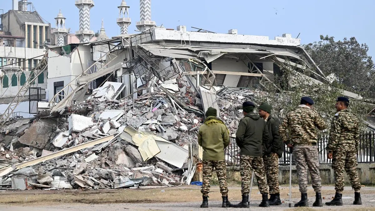 Rubble after the demolition with security personnel on site